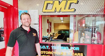 Man in front of his CMC shop