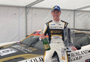 James Kellett sitting on racing car