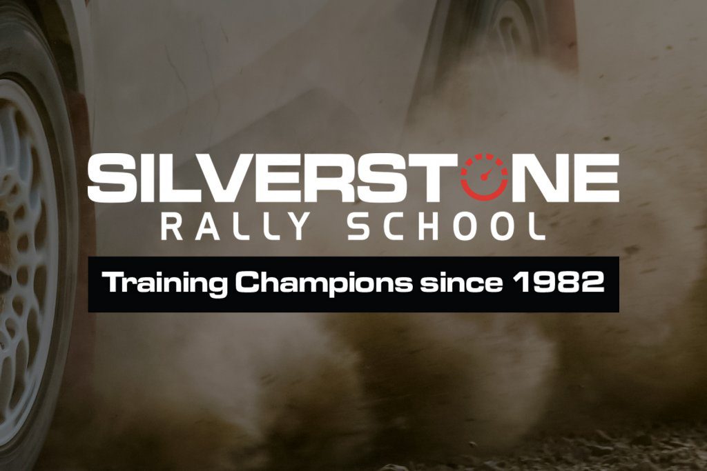 A racing car creating a dust wave on the track with the Silverstone Rally School logo in the middle