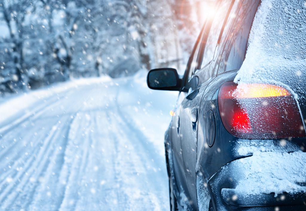 Car driving in snowy weather