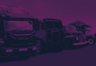 Purple image of a line of trucks parked