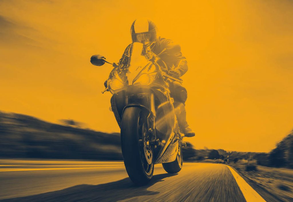 Orange photo of a man on a motorcycle