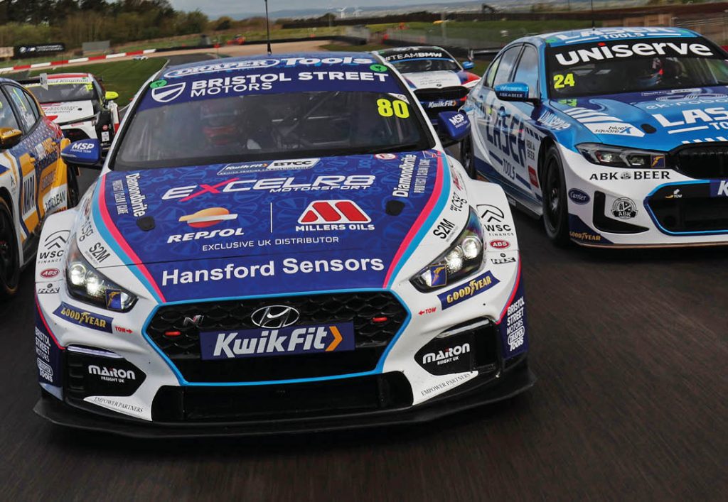 Image of the 2024 EXCELR8 BTCC car on the track with the other cars