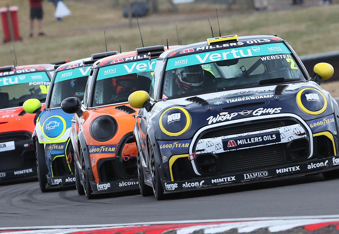Photo of 4 MINI CHALLENGE JCW MINIs, one in front of the other, with Albert Webster at the front